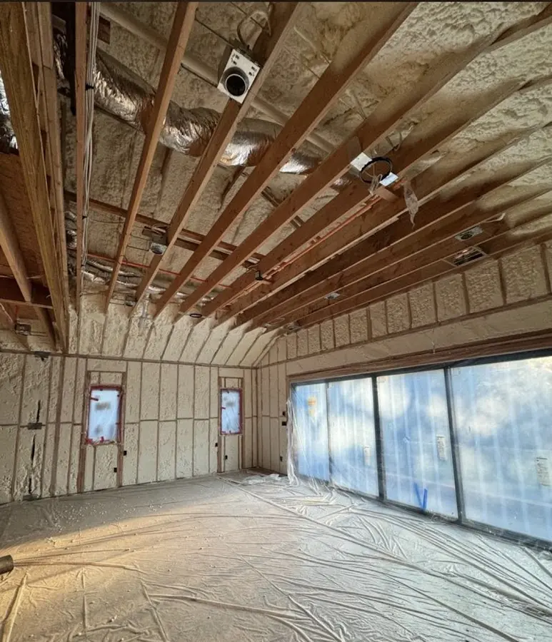 Interior walls and ceiling insulated with spray foam during new construction in Montpelier